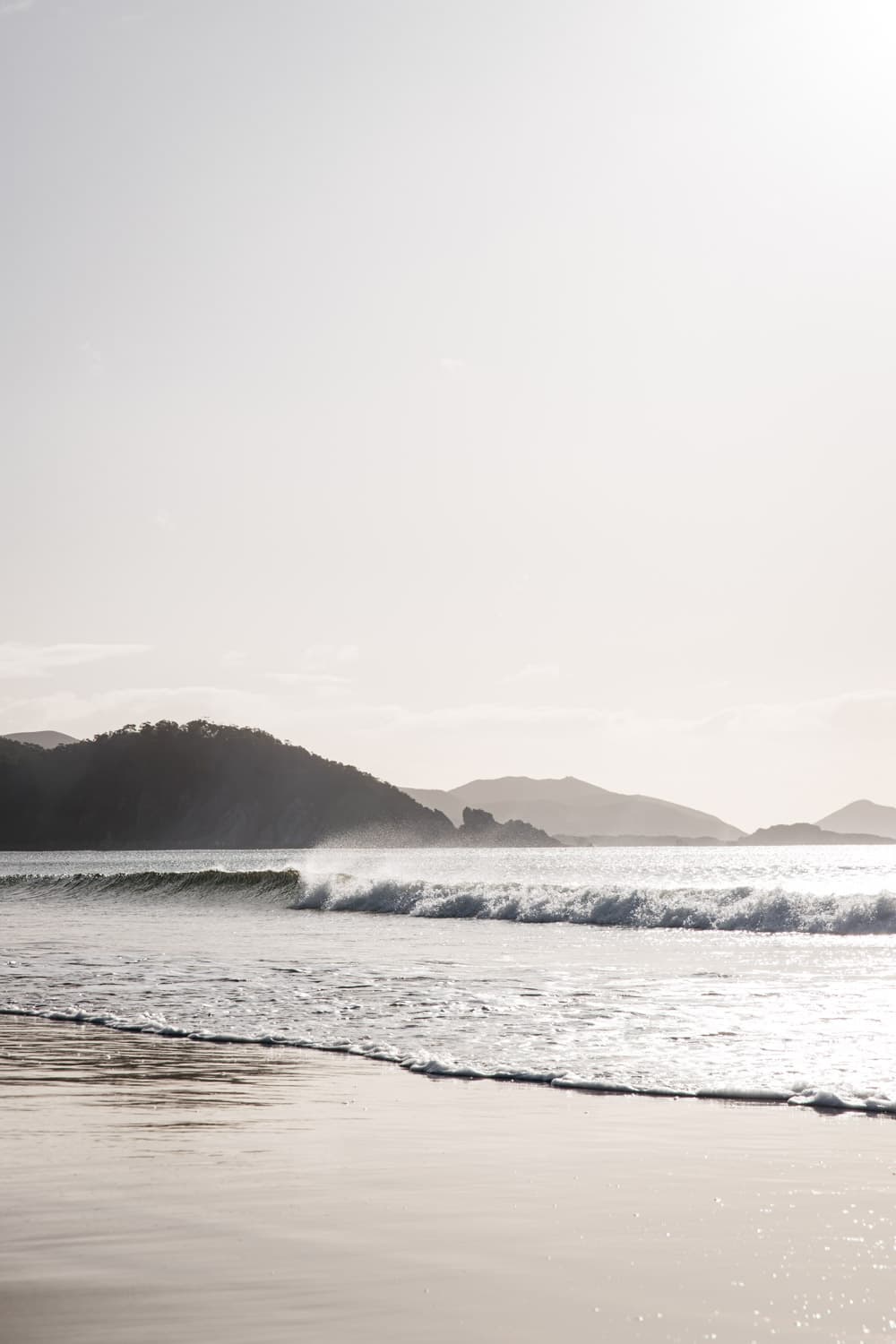 Watching waves rolling in at water's edge